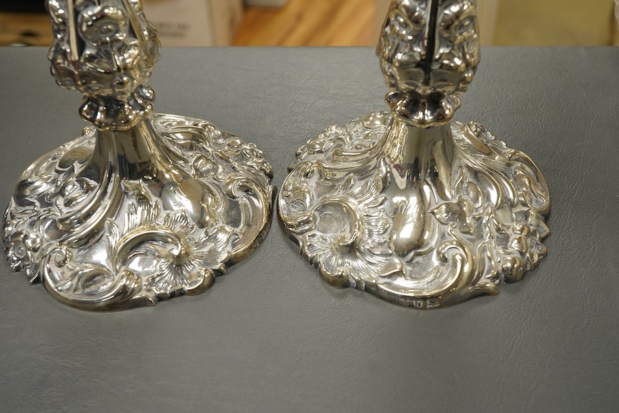 A pair of late Victorian silver candlesticks, with foliate decoration, by Walker & Hall, Sheffield, 1899, height 23cm, weighted.
